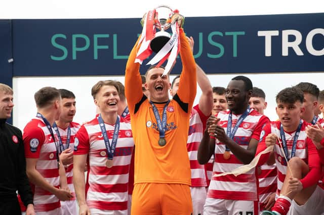 Man-of-the-match Ryan Fulton lifts the SPFL Trust Trophy after a tremendous performance against Raith Rovers.