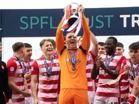Man-of-the-match Ryan Fulton lifts the SPFL Trust Trophy after a tremendous performance against Raith Rovers.