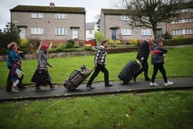 Syrian refugee families arriving at their new homes on the Isle of Bute  in 2015. The number of refugees granted asylum in Scotland has plummeted due to the pandemic.