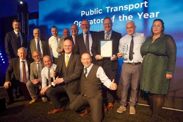 The McGill's Buses team collecting their public transport operator of the year award with awards host Grant Stott, left. Picture: Transport Times