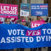 Supporters of a law change on assisted dying demonstrate outside the Scottish Parliament in May last year (Picture: Lisa Ferguson)