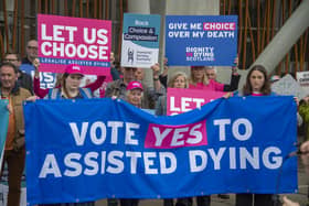 Supporters of a law change on assisted dying demonstrate outside the Scottish Parliament in May last year (Picture: Lisa Ferguson)