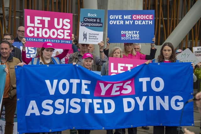Supporters of a law change on assisted dying demonstrate outside the Scottish Parliament in May last year (Picture: Lisa Ferguson)