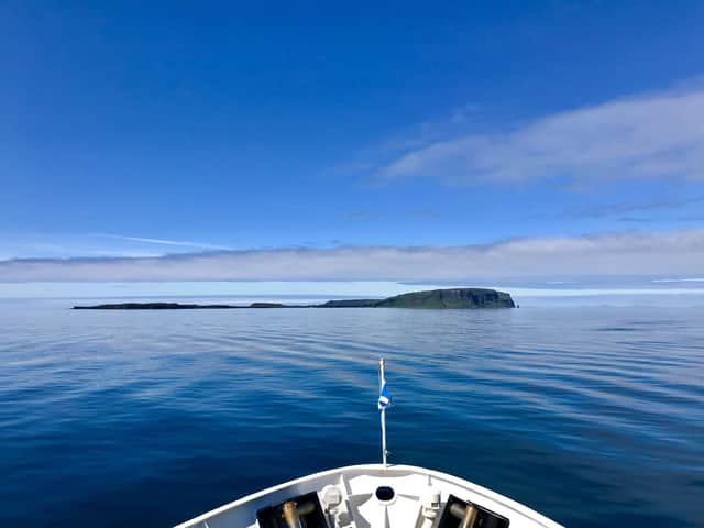 A boat approaches the Isle of Canna, which sits to the south west of Skye. A crowdfunding appeal has been launched to help build new houses on the island to help grow its population. PIC: NTS.