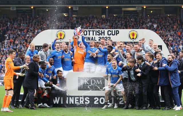 Rangers goalkeeper Allan McGregor (centre) lifts the Scottish Cup whilst his team-mates celebrate after the final whistle of the Scottish Cup final at Hampden Park, Glasgow.