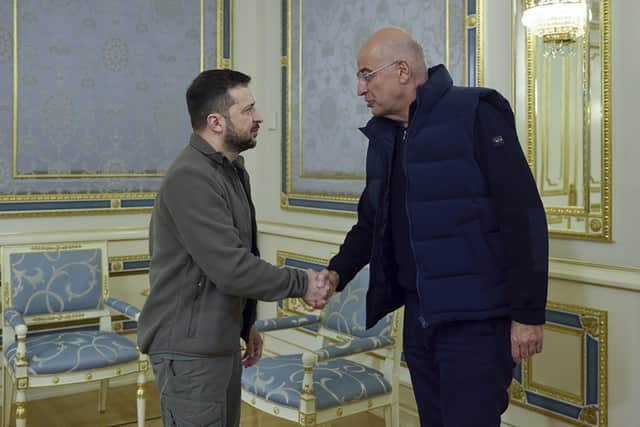 Support: Ukrainian President Volodymyr Zelenskyy, left, shakes hands with Greek Foreign Minister Nikos Dendias in Kyiv