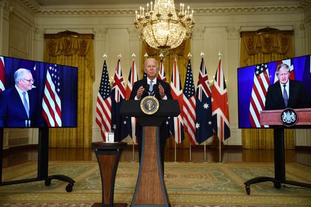 US President Joe Biden participates is a virtual press conference on national security with British Prime Minister Boris Johnson (right) and Australian Prime Minister Scott Morrison (left) in the East Room of the White House in Washington, DC. Picture: Brendan Smialowski/AFP via Getty Images