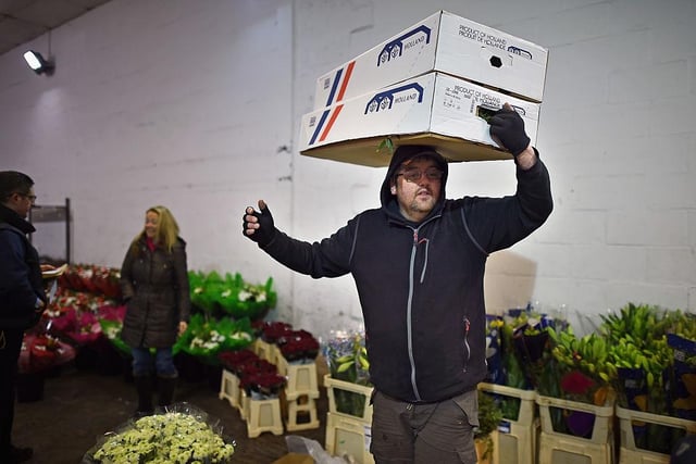 Staff and customers at Johnston and Scott flower merchants, in Glasgow, prepare flowers for delivery to florists in time for Valentines Day 2015.