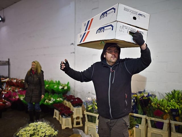 Staff and customers at Johnston and Scott flower merchants, in Glasgow, prepare flowers for delivery to florists in time for Valentines Day 2015.