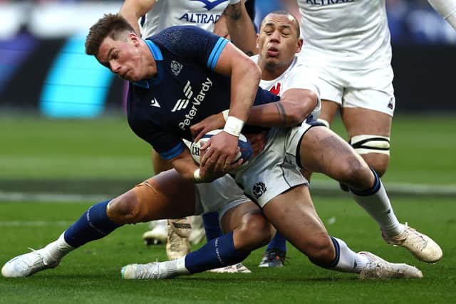 Scotland centre Huw Jones grapples for the ball with France's Gael Fickou during the Six Nations defeat in Paris. (Photo by ANNE-CHRISTINE POUJOULAT/AFP via Getty Images)