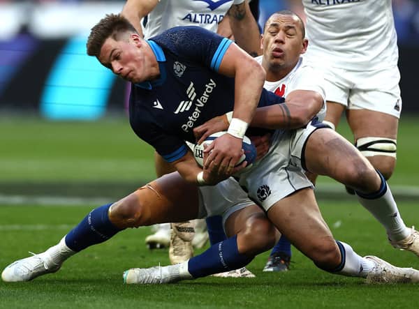 Scotland centre Huw Jones grapples for the ball with France's Gael Fickou during the Six Nations defeat in Paris. (Photo by ANNE-CHRISTINE POUJOULAT/AFP via Getty Images)