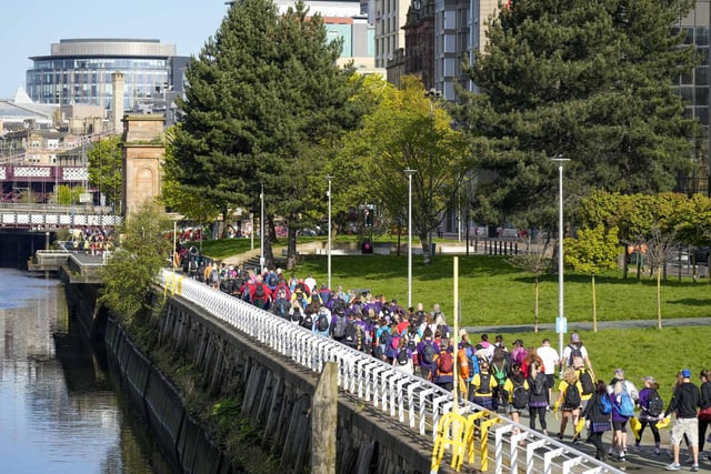 The thousands of walkers make their way along the River Clyde