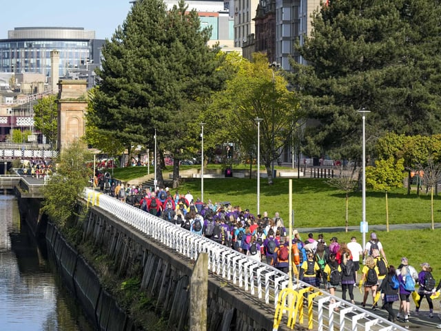 The thousands of walkers make their way along the River Clyde