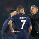 Kylian Mbappe of Paris Saint-Germain is consoled by Luis Enrique after the French champions lost out to Borussia Dortmund.