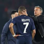 Kylian Mbappe of Paris Saint-Germain is consoled by Luis Enrique after the French champions lost out to Borussia Dortmund.
