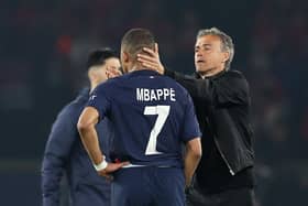 Kylian Mbappe of Paris Saint-Germain is consoled by Luis Enrique after the French champions lost out to Borussia Dortmund.