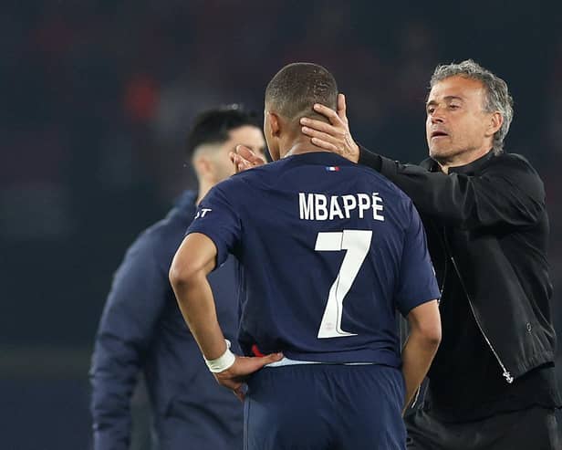 Kylian Mbappe of Paris Saint-Germain is consoled by Luis Enrique after the French champions lost out to Borussia Dortmund.