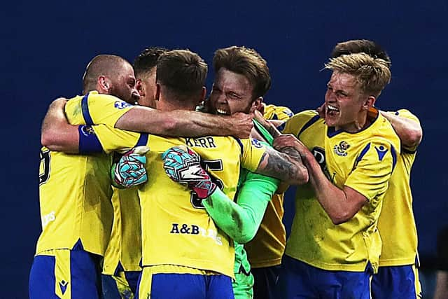 St Johnstone goalkeeper Zander Clark celebrates with his team-mates after the dramatic 122nd minute equaliser in the Scottish Cup quarter-final win over Rangers at Ibrox. (Photo by Ian MacNicol/Getty Images)