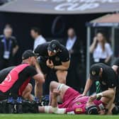 Jonny Gray is treated by the Exeter Chiefs medical staff after dislocating his left knee against La Rochelle.
