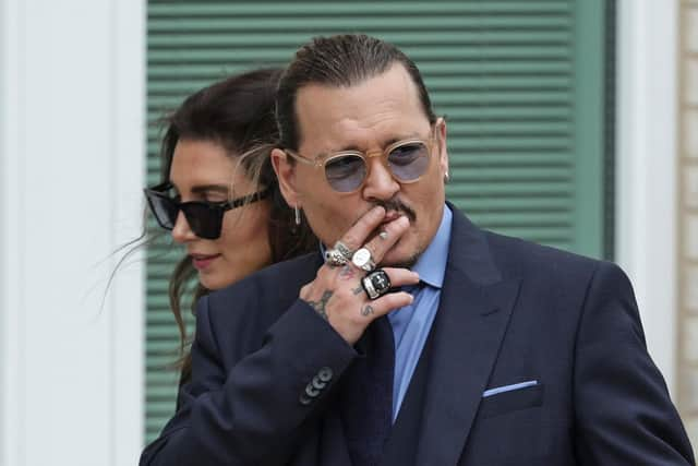 FAIRFAX, VIRGINIA - MAY 27: Actor Johnny Depp smokes during a break in his trial at a Fairfax County Courthouse on May 27, 2022 in Fairfax, Virginia. Closing arguments in the Depp v. Heard defamation trial, brought by Johnny Depp against his ex-wife Amber Heard, begins today. (Photo by Kevin Dietsch/Getty Images)