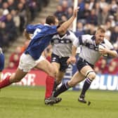 France's Olivier Brouzet can't quite catch Scotland's Glenn Metcalfe during a Six Nations encounter in 2003. Pic supplied by: Eric McCowat.