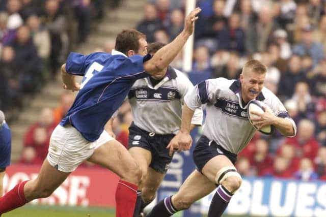 France's Olivier Brouzet can't quite catch Scotland's Glenn Metcalfe during a Six Nations encounter in 2003. Pic supplied by: Eric McCowat.