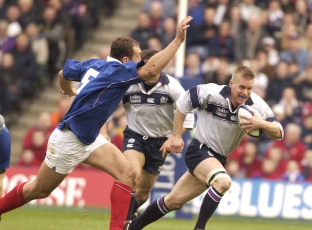 France's Olivier Brouzet can't quite catch Scotland's Glenn Metcalfe during a Six Nations encounter in 2003. Pic supplied by: Eric McCowat.