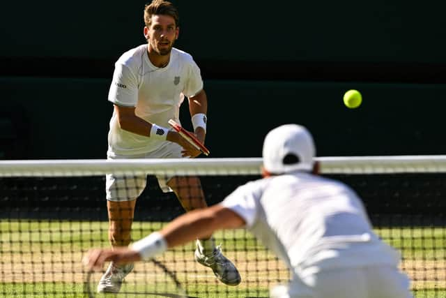 Cameron Norrie faces a Novak Djokovic serve during the men's singles semi final match at Wimbledon. (Photo by SEBASTIEN BOZON/AFP via Getty Images)