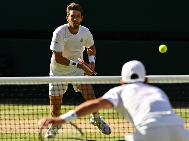 Cameron Norrie faces a Novak Djokovic serve during the men's singles semi final match at Wimbledon. (Photo by SEBASTIEN BOZON/AFP via Getty Images)