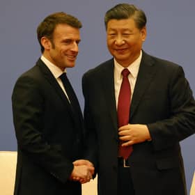 French President Emmanuel Macron and Chinese President Xi Jinping shake hands at a Franco-Chinese business council meeting in Beijing yesterday (Picture: Ludovic Marin/pool/AFP via Getty Images)