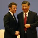 French President Emmanuel Macron and Chinese President Xi Jinping shake hands at a Franco-Chinese business council meeting in Beijing yesterday (Picture: Ludovic Marin/pool/AFP via Getty Images)