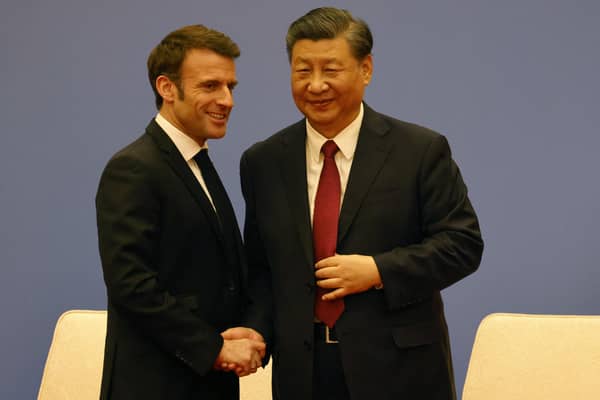 French President Emmanuel Macron and Chinese President Xi Jinping shake hands at a Franco-Chinese business council meeting in Beijing yesterday (Picture: Ludovic Marin/pool/AFP via Getty Images)