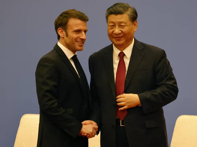 French President Emmanuel Macron and Chinese President Xi Jinping shake hands at a Franco-Chinese business council meeting in Beijing yesterday (Picture: Ludovic Marin/pool/AFP via Getty Images)
