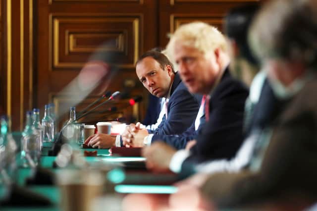 Matt Hancock, who has resigned as Health Secretary, looks towards Boris Johnson during a Cabinet meeting last July (Picture: Simon Dawson - WPA Pool/Getty Images)