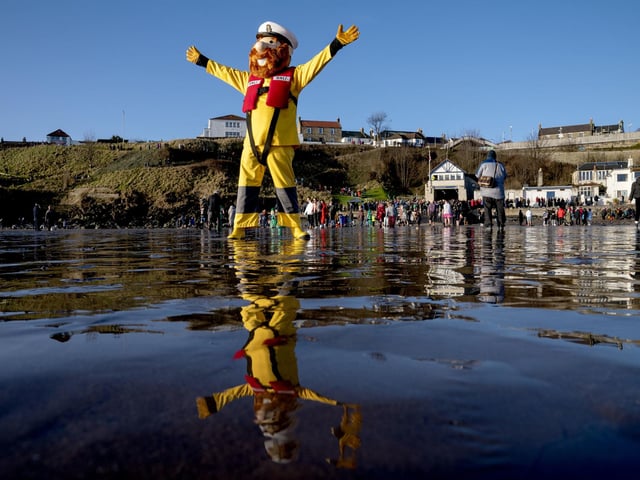 The RNLI mascot on the beach at the Loony Dook New Year's Day dip in the Firth of Forth at Kinghorn in Fife.