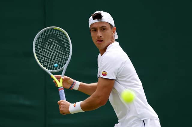 Ryan Peniston of Great Britain playing against Steve Johnson during the second round of men's singles at Wimbledon 2022 (Photo by Clive Brunskill/Getty Images)
