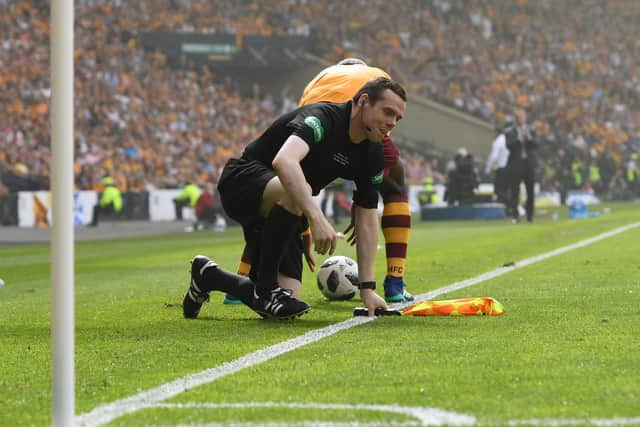 Linesman Douglas Ross takes a tumble