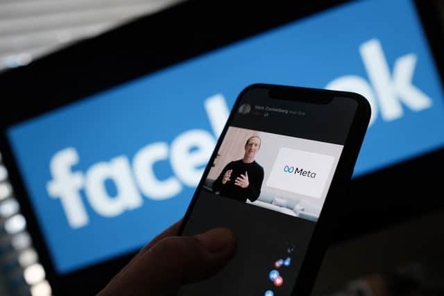 A person watches on a smartphone Facebook CEO Mark Zuckerberg unveil the META logo.. Picture:  Chris DELMAS / AFP) (Photo by CHIS DELMAS/AFP via Getty Images