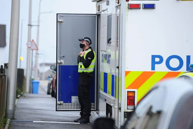 Standing guard: A mobile command unit outside Mr Coutts' former home