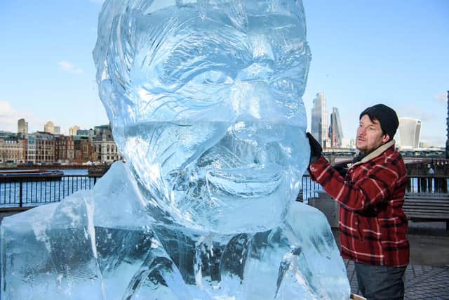 Sculptor Jamie Hamilton puts the finishing touches to a two-metre-tall ice-sculpture of Sir David Attenborough, designed to demonstrate the rate of the Arctic sea ice melt caused by one person's carbon emissions in the UK every fortnight (Picture: Matt Crossick/PA)