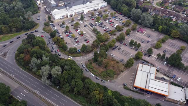 Cars queue for fuel at a Sainsbury's petrol station in Camberley, Surrey.