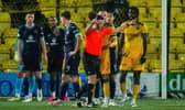 Referee Grant Irvine checks VAR during the match between Livingston and Hibs.