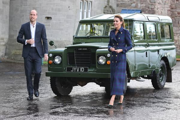 The Duke and Duchess of Cambridge arrive, in a Land Rover that previously belonged to the Duke of Edinburgh