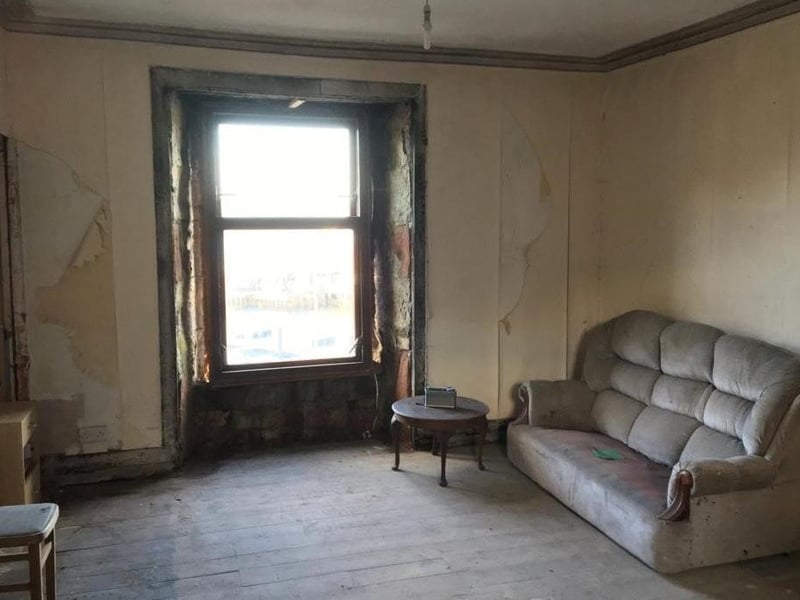 The living room, complete with sofa and radio.
