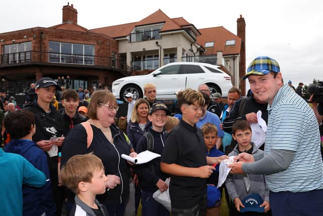 Bob MacIntyre autographs for young fans during the Genesis Scottish Open Pro-Am at The Renaissance Club. Picture: Andrew Redington/Getty Images.