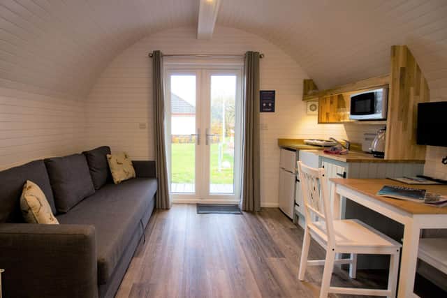 An interior of one of the Highland Pods, with kitchenette, double bed, sofa bed and shower room/wc.