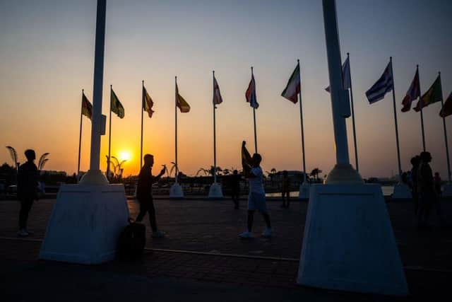 People visit the FIFA World Cup countdown clock in Doha on October 23, 2022, ahead of the Qatar 2022 FIFA World Cup football tournament.