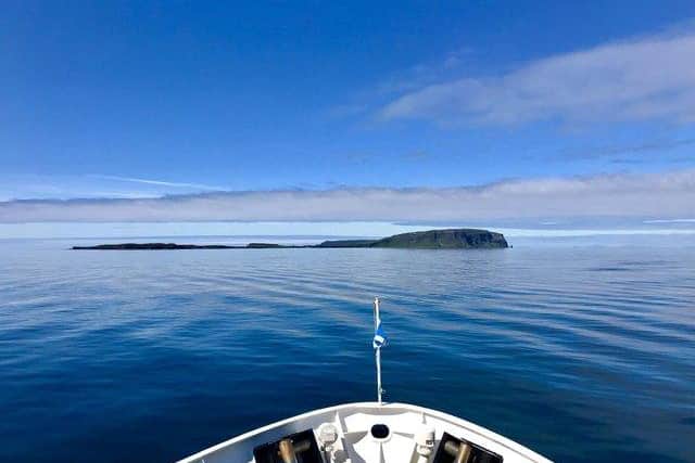 A boat approaches the Isle of Canna, which sits to the south west of Skye. A crowdfunding appeal has been launched to help build new houses on the island to help grow its population. PIC: NTS.