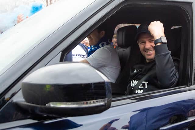 Rangers manager Steven Gerrard raises a fist in celebration at the club's Auchenhowie training base after the title was confirmed. (Photo by Ross MacDonald / SNS Group)