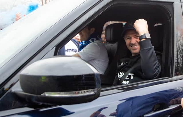 Rangers manager Steven Gerrard raises a fist in celebration at the club's Auchenhowie training base after the title was confirmed. (Photo by Ross MacDonald / SNS Group)